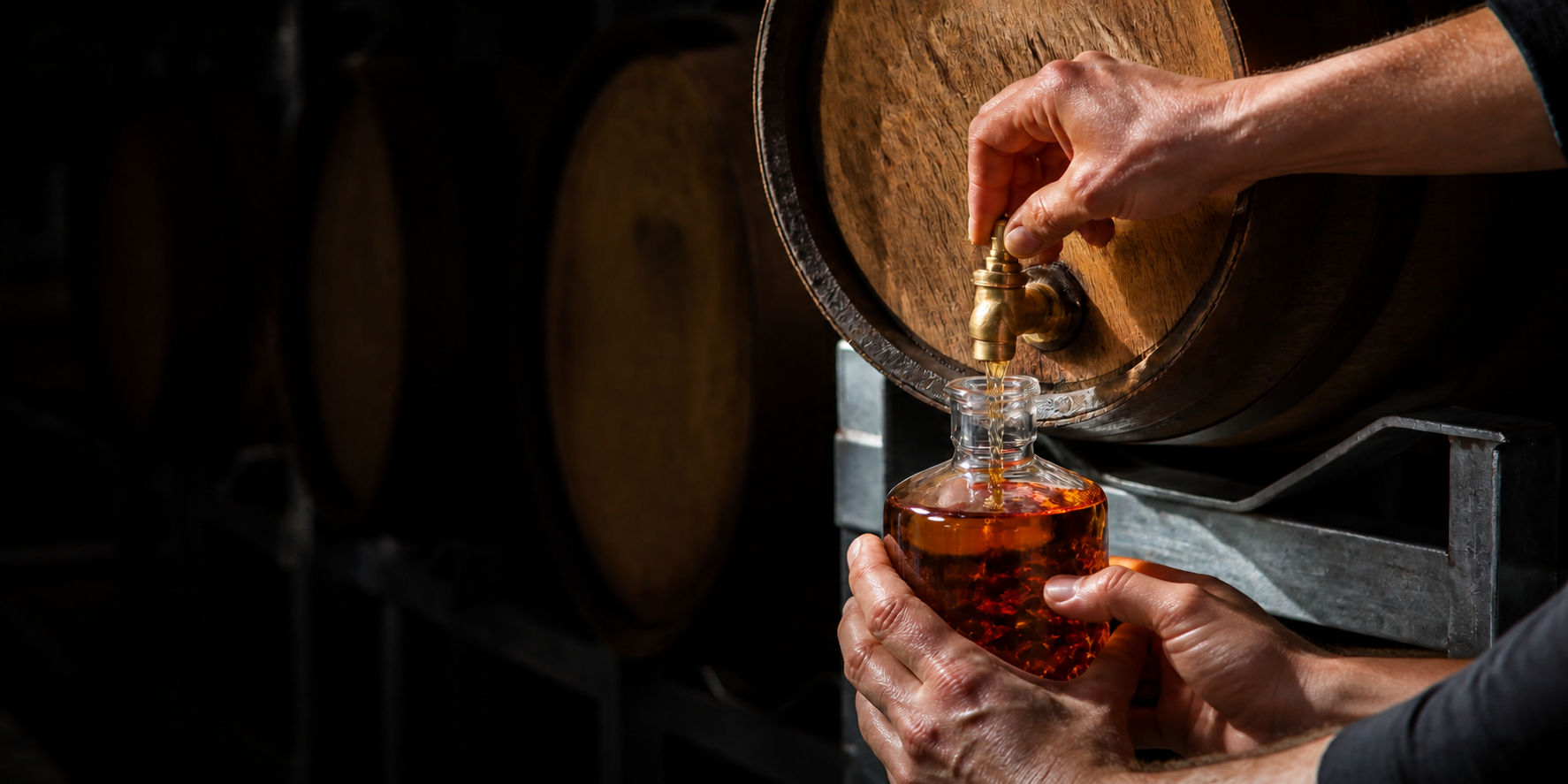 Two adults filling a 500ml whisky bottle from a tapped barrel at Manly Spirits.