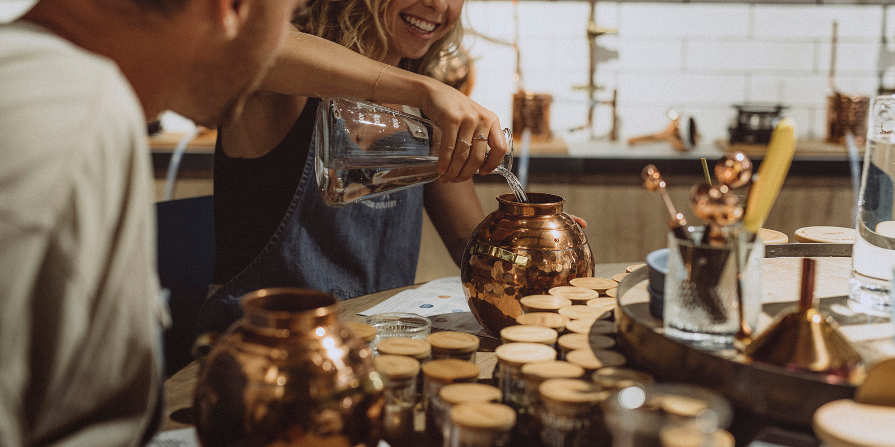 Guests making gin with mini copper stills at Manly Spirits Gin School.