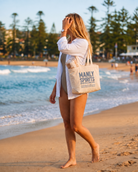 Manly Spirits Distilling Co. canvas tote bag carried on the beach