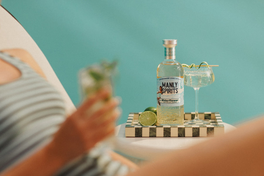 Elderflower Liqueur and a Hugo Spritz against a turquoise wall